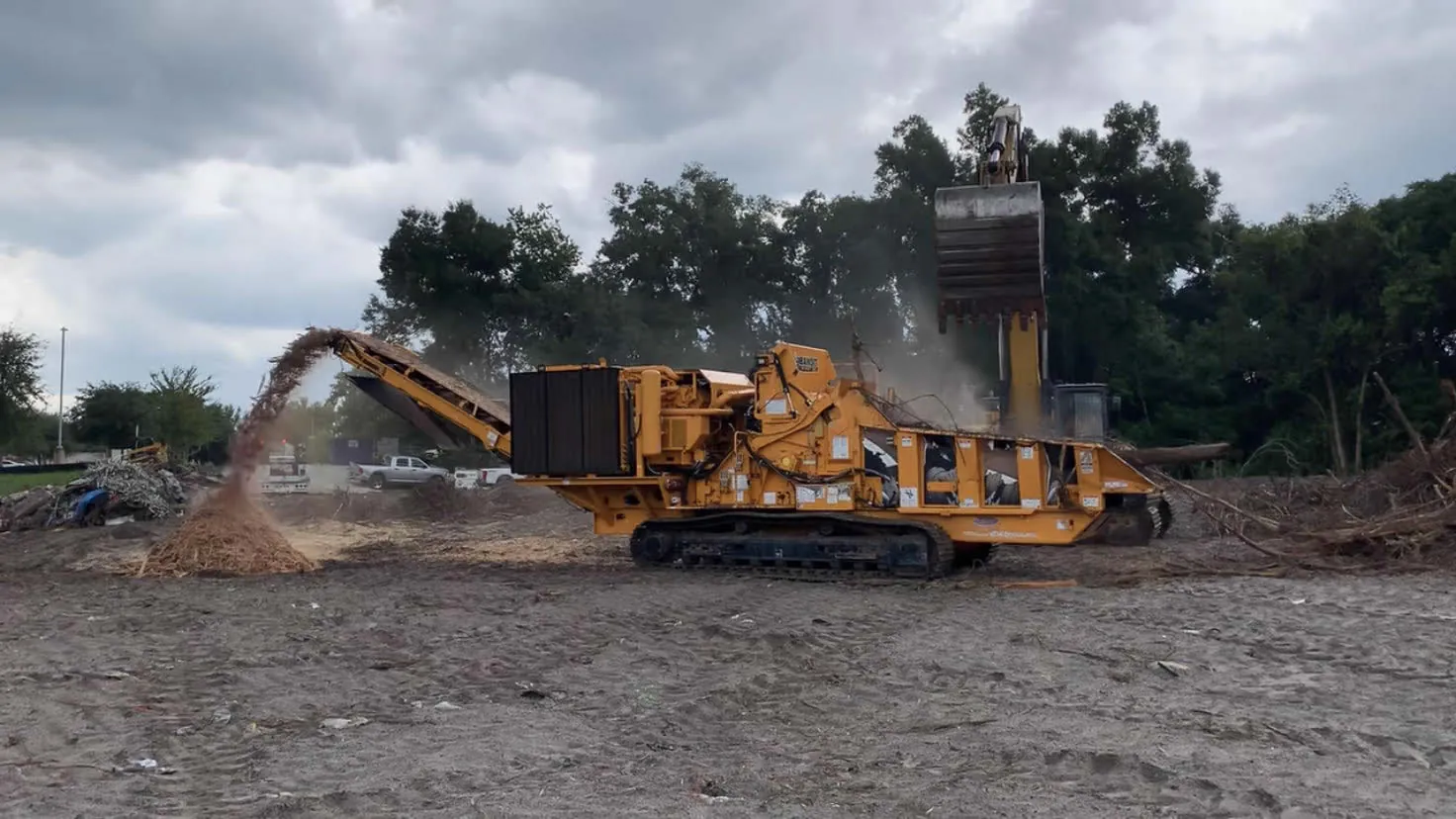Equipment grinding tree debris